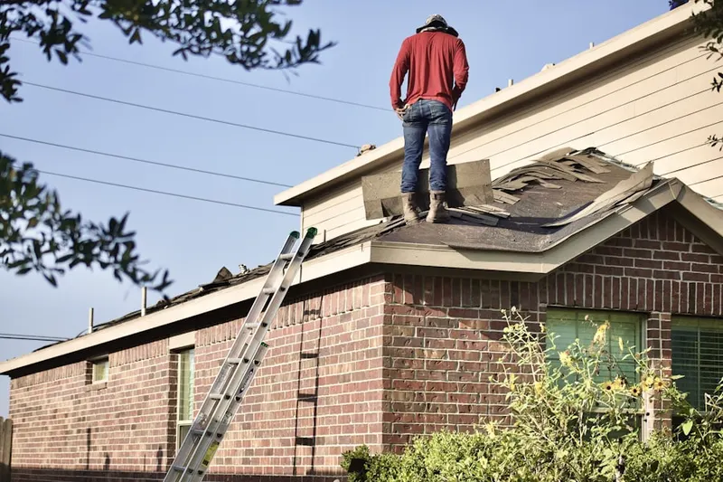 Professional roofer working on a residential roof in East Massapequa